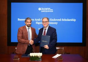 Two men shaking hands after signing agreement