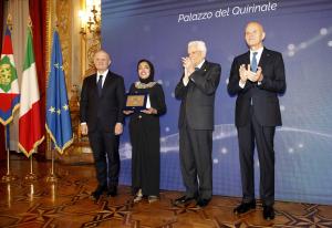 Shima Farag is standing between the President of Italy and the CEO of Eni Company