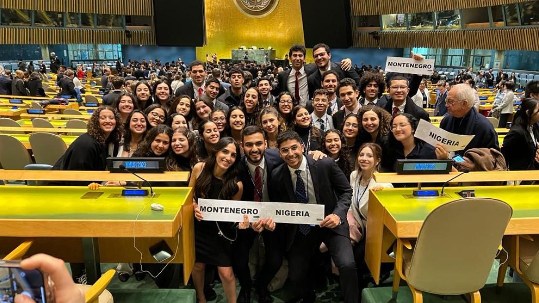 A group of students wearing suits holding a certificate