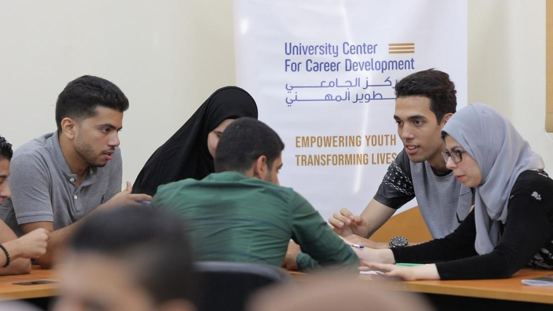 Group of students sitting around a table in classroom