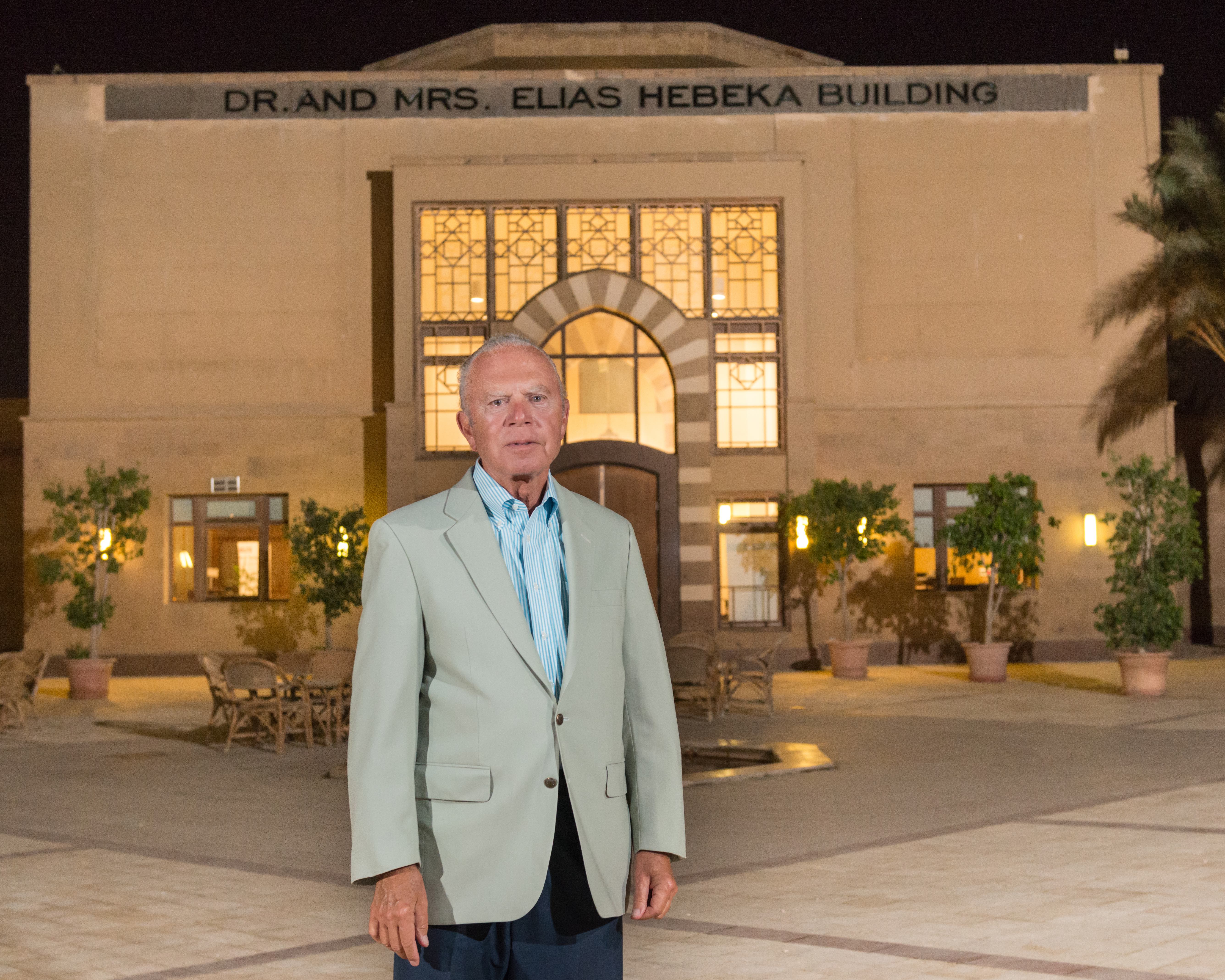 The late Elias Hebeka standing in front of the building in his name on campus 