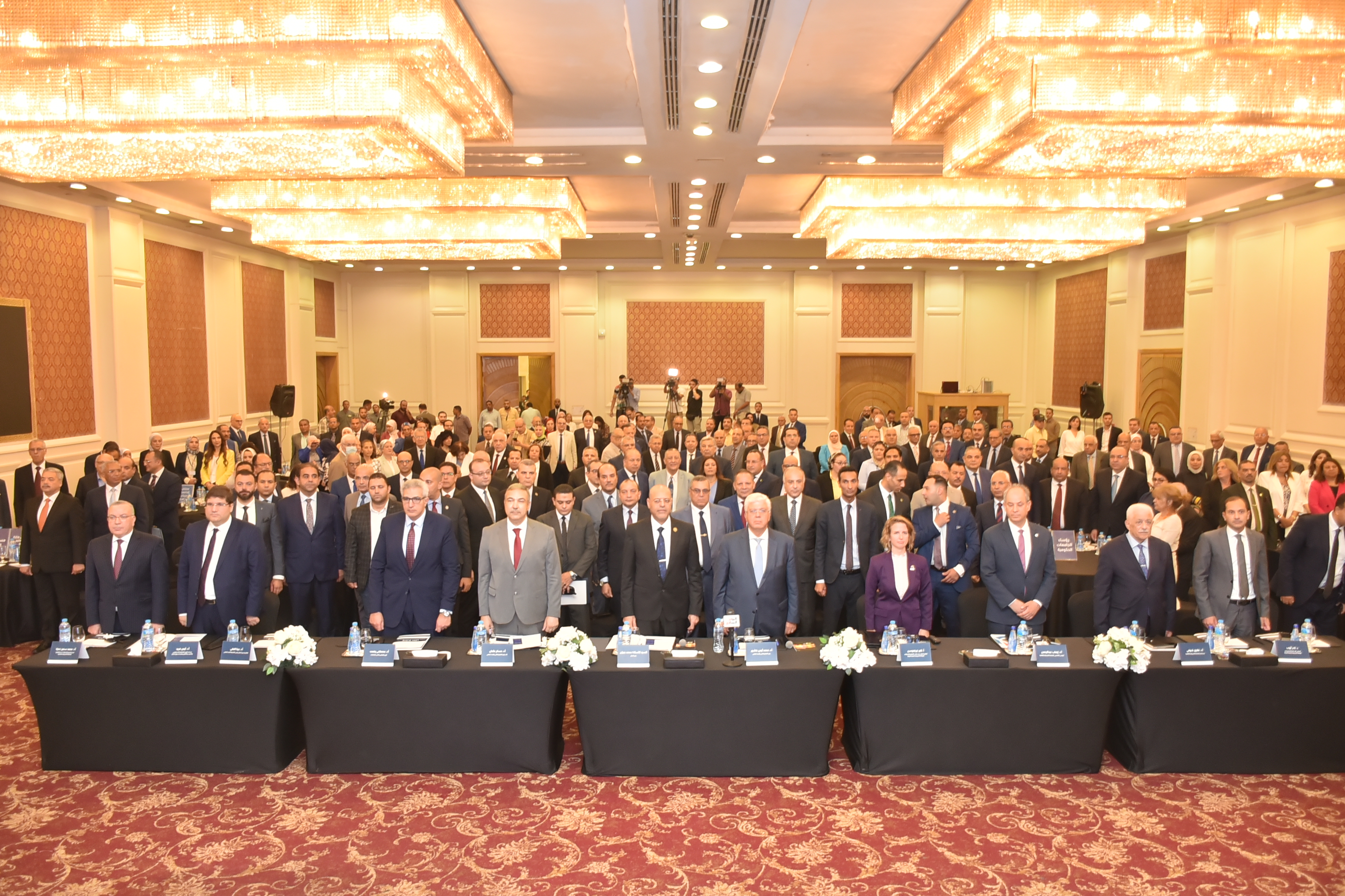 a group of men wearing suits taking a group photo