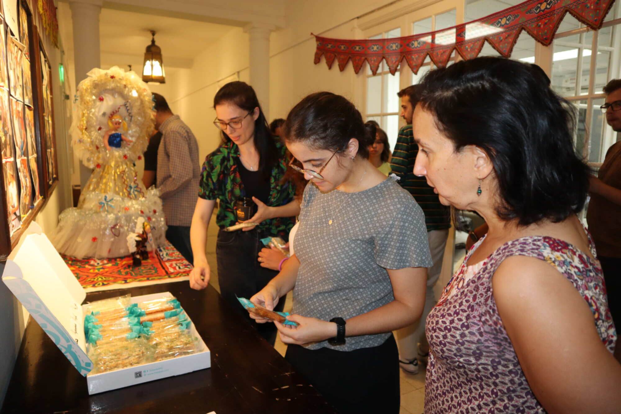 students at mawled el nabawy celebration choosing sweets from a box