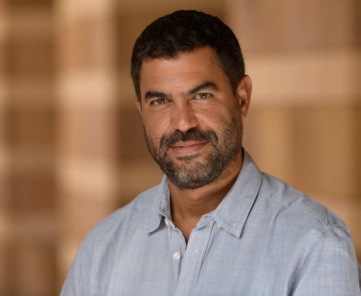 headshot of a man smiling