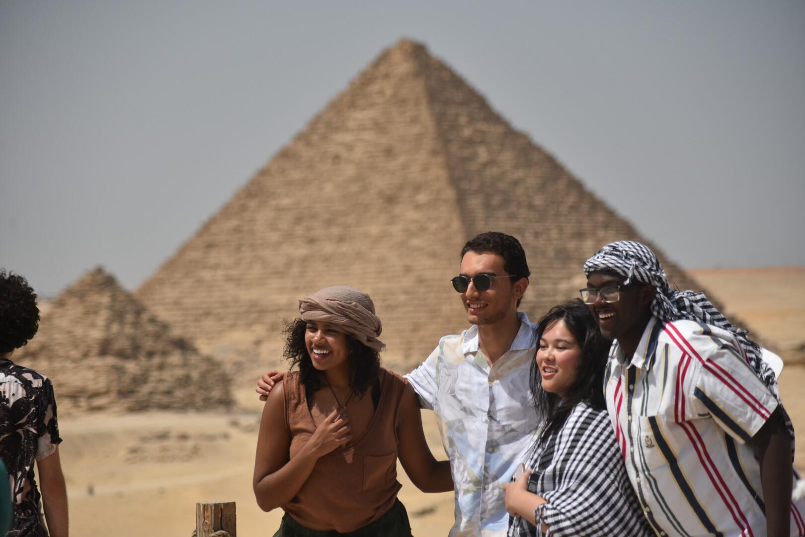 A group of international students taking a picture at the pyramids