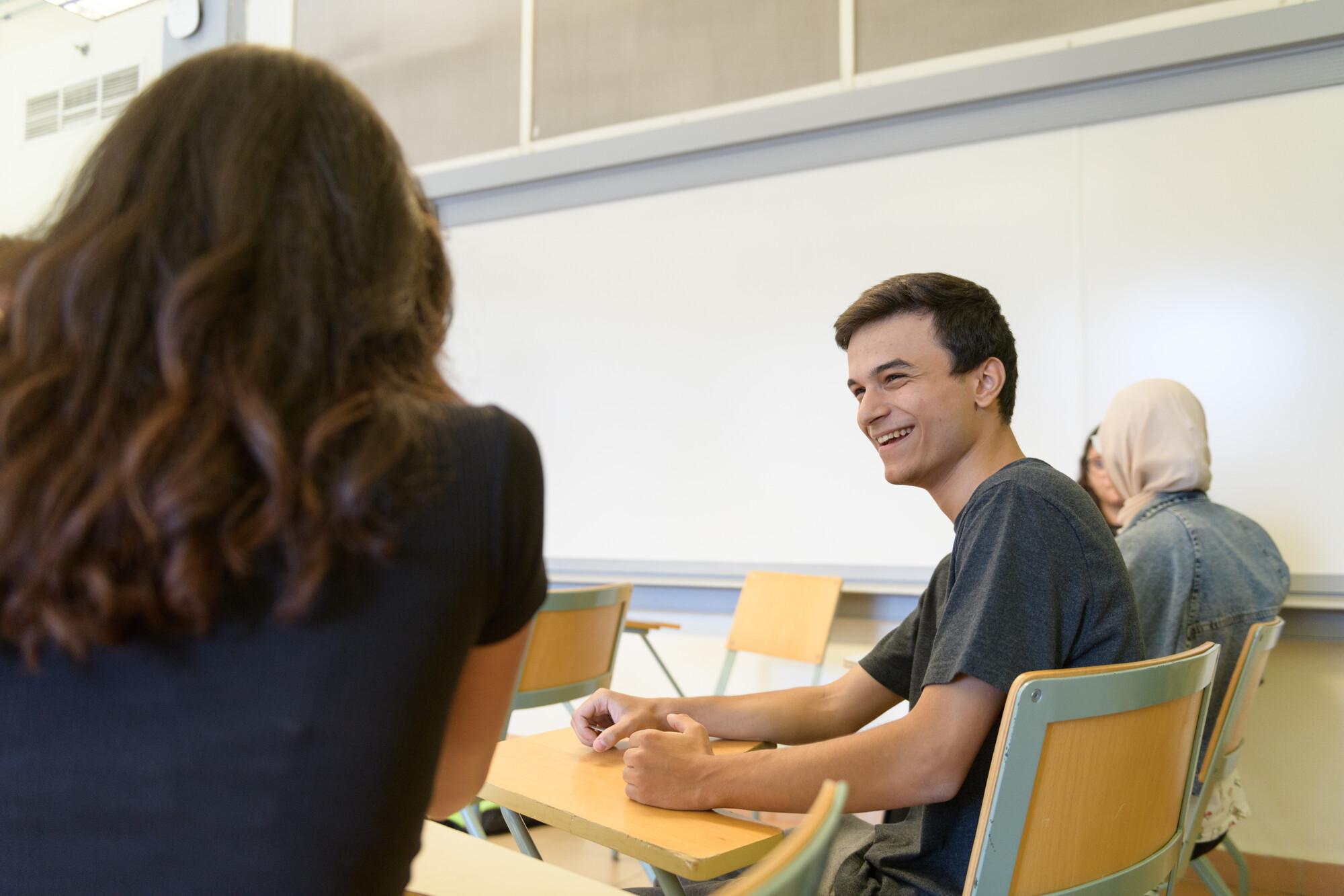 two students working on a class project together 