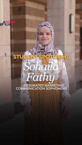 A veiled student, Sohaila Fathy, is standing. Textr: Student Spotlight Sohaila Fathy, Integrated Marketing Communication Sophomore