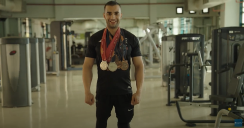 Employee Adel Elhout is wearing the medals that he won