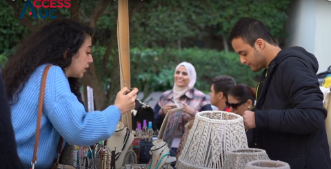 A female is asking a male seller at a shopping outlet