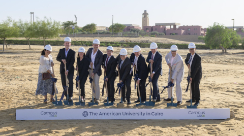 a group of senior leaders standing next to each other each holding a shovel at the campus 2026 construction site