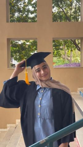 a girl wearing a black cap and gown for her graduation party