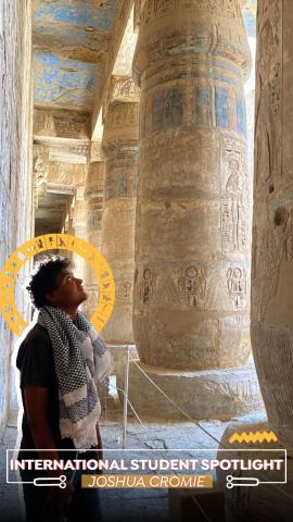 An international student is looking at pharaonic pillars. Text: International Students Spotlight Joshua Cromie