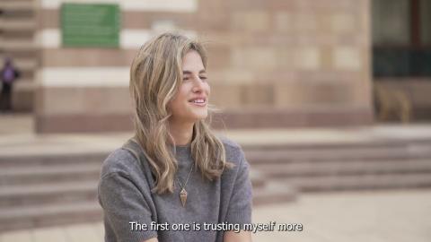 A female is talking and smiling