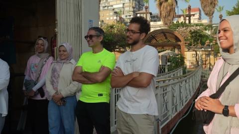 Males and veiled females standing and smiling