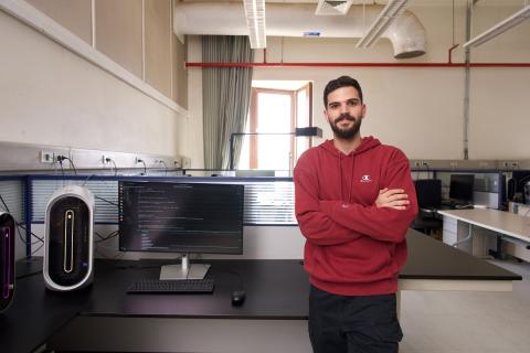 A male is standing in a computer lab