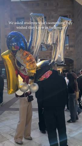 People holding balloons, one with the letter M. Text: We asked students what's something they wished they knew  as freshmen