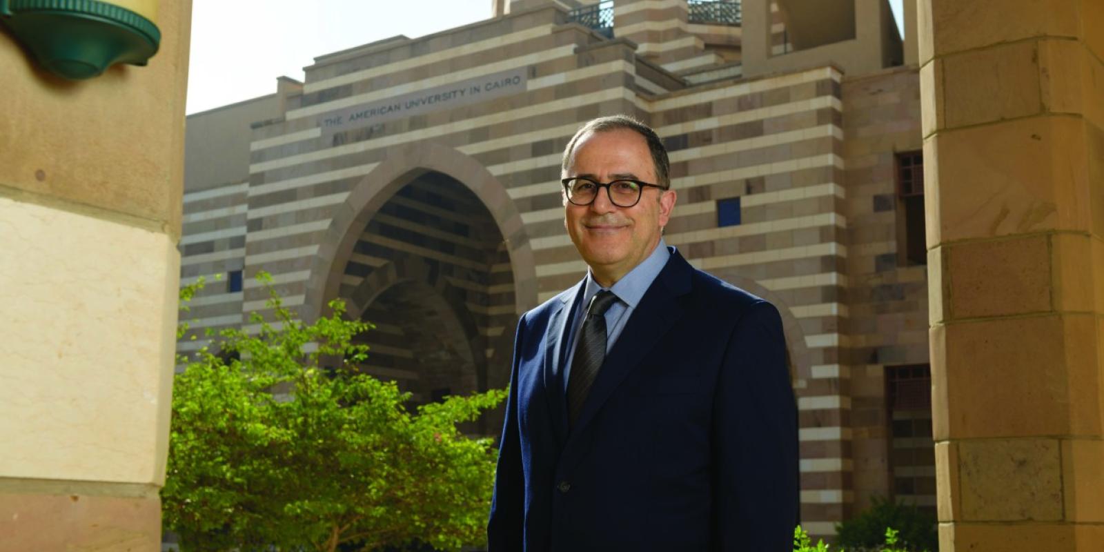 AUC President Ahmad Dallal standing in front of Portal