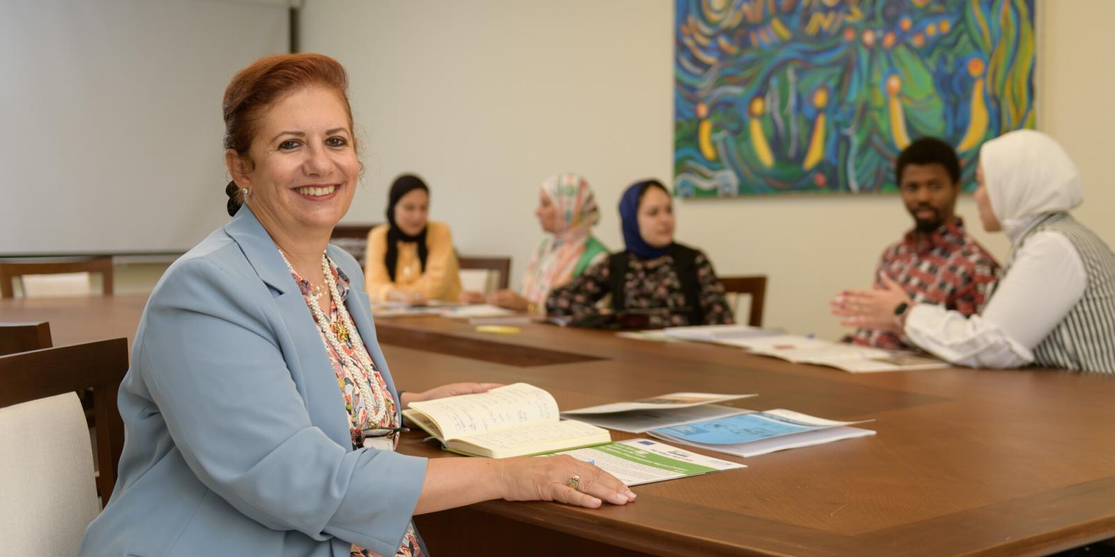 People in class and a woman smiling