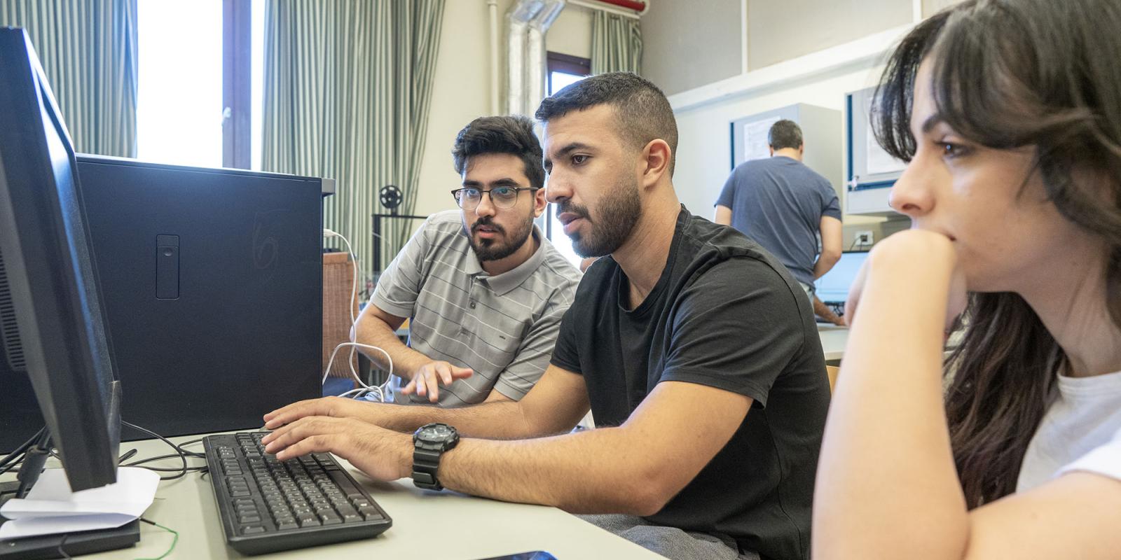 computer program image of group students working on a group project on a computer