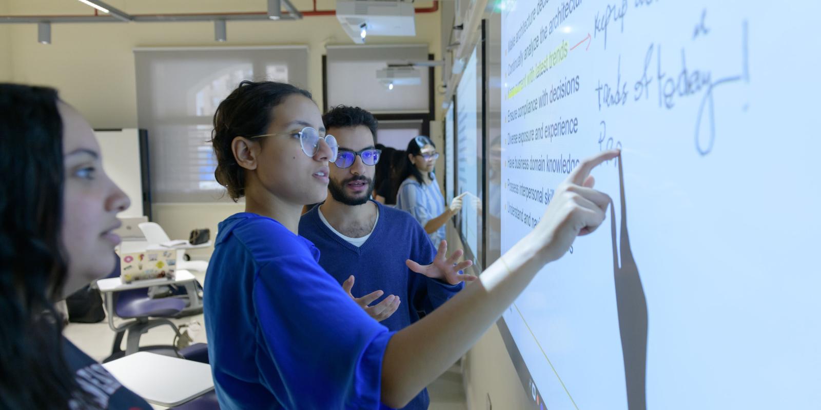 Teaching and Learning Banner image of student writing on white board