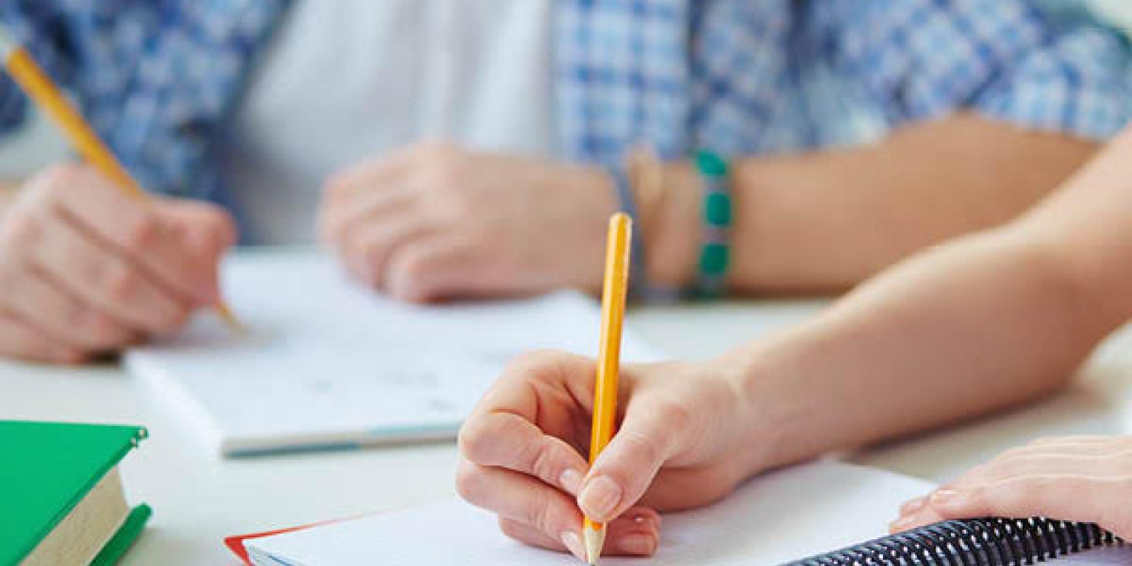 Boy writing in a notebook