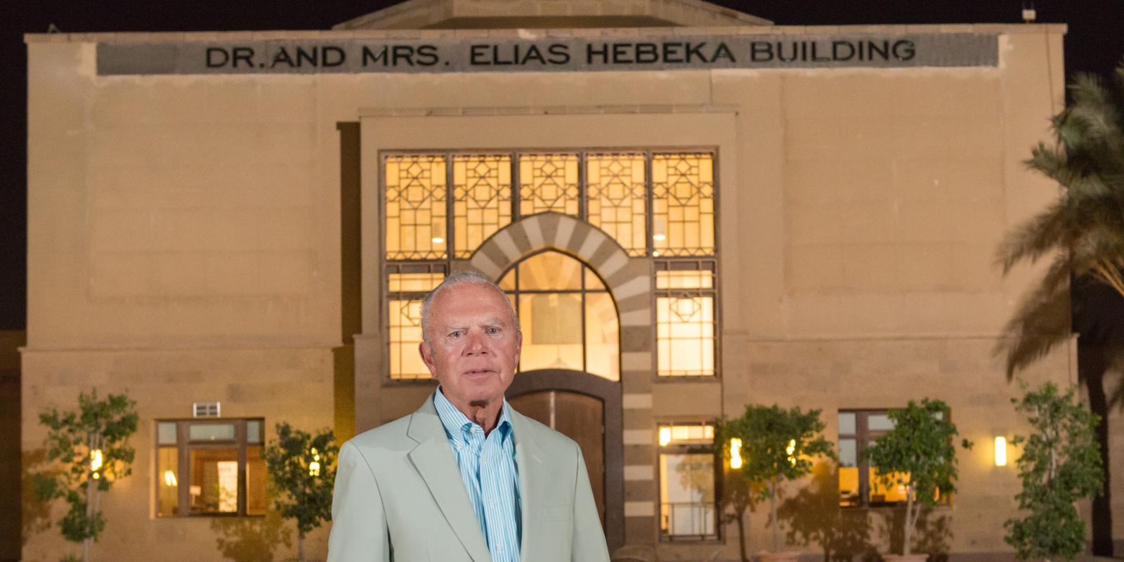 The late Elias Hebeka standing in front of the building in his name on campus 