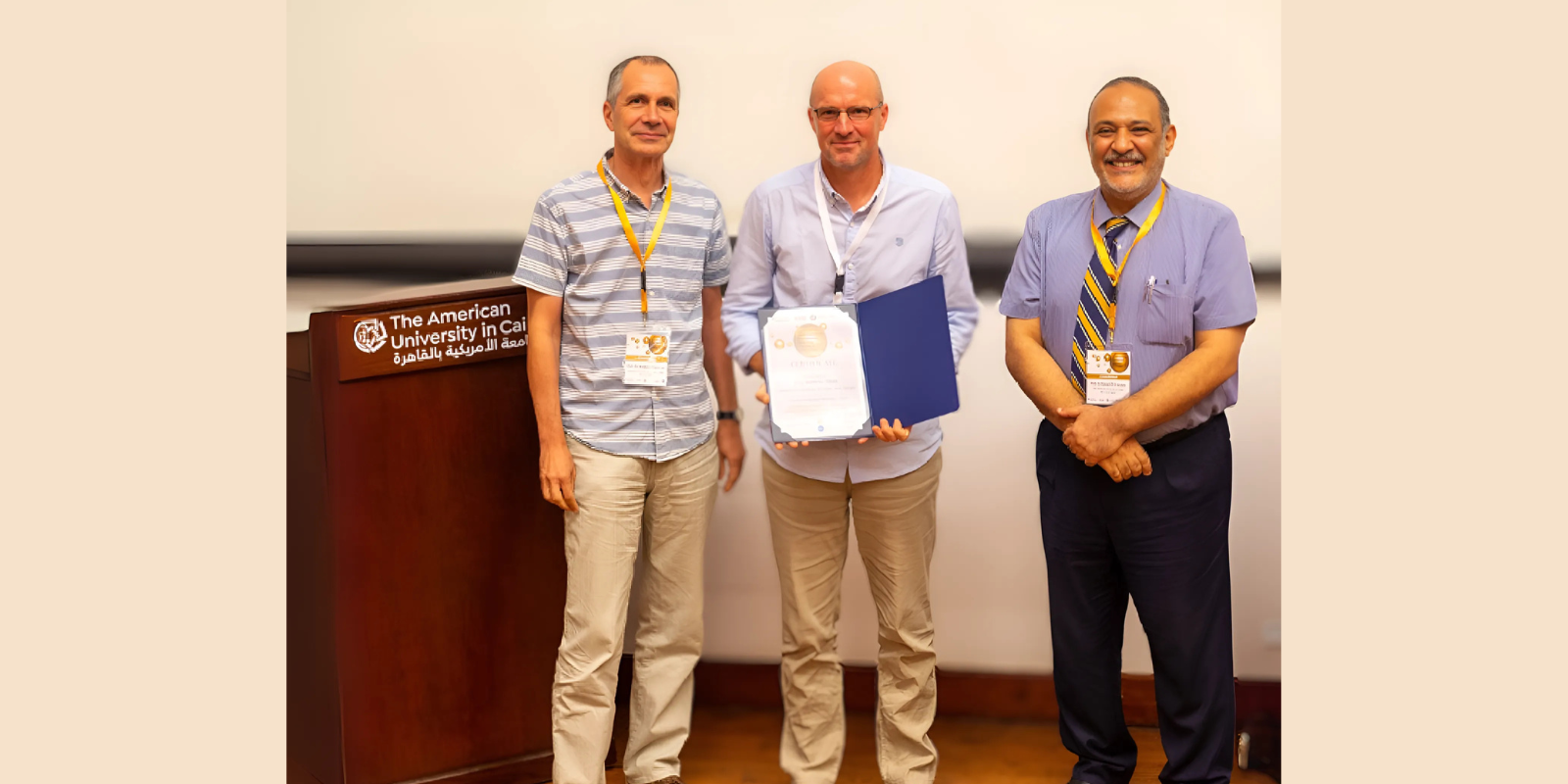 Hassan Azzazy (right) stands smiling with two other men who are part of the plasmonic sensing network.