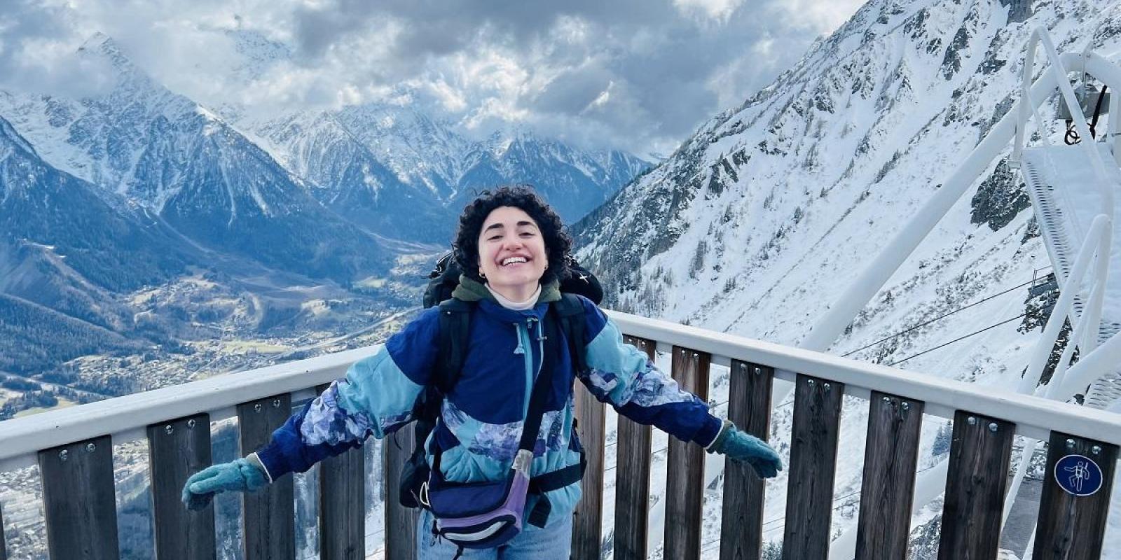 Girl student in the snowy mountains in a study abroad trip