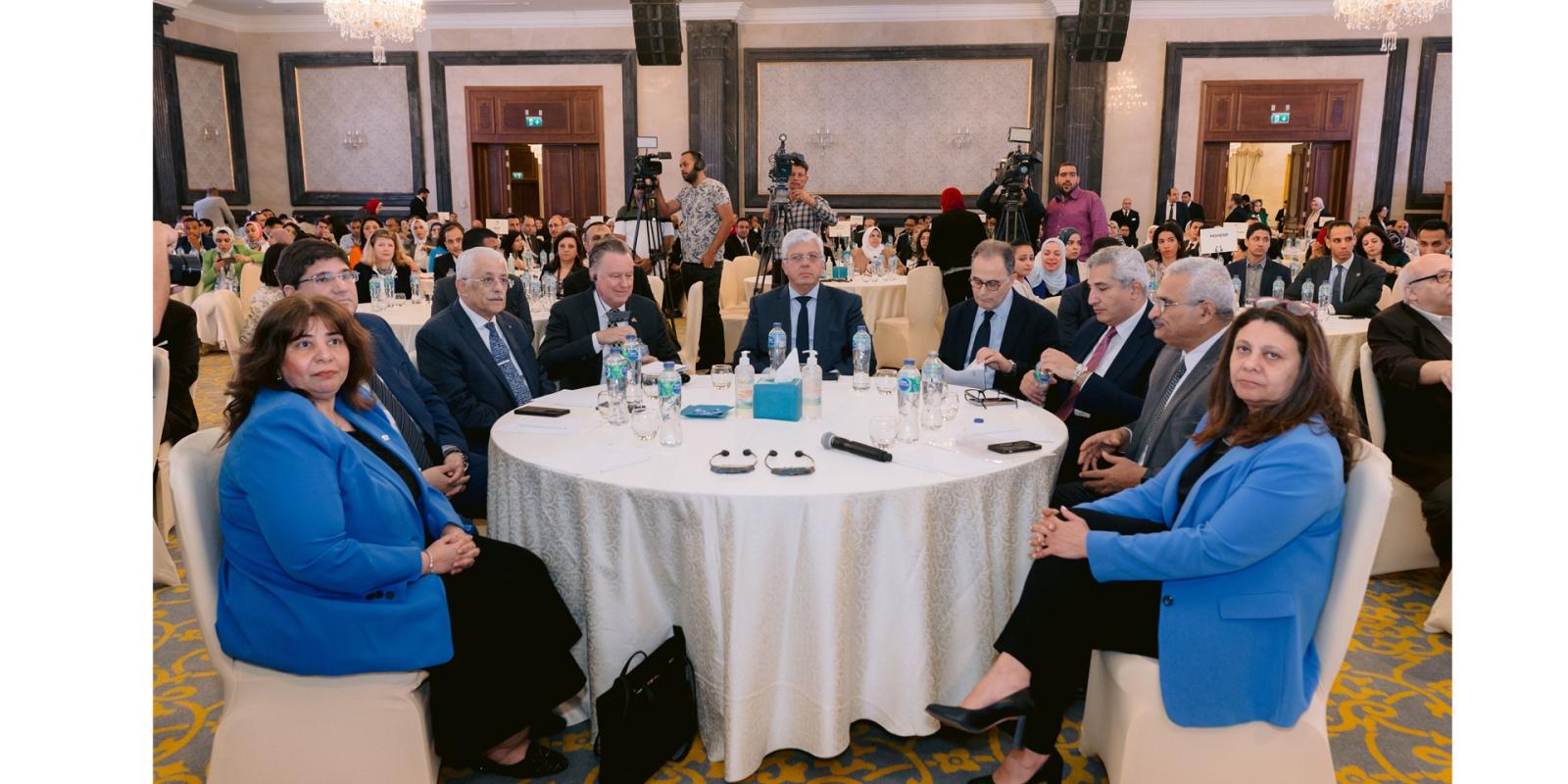 a group of people sitting on a round table