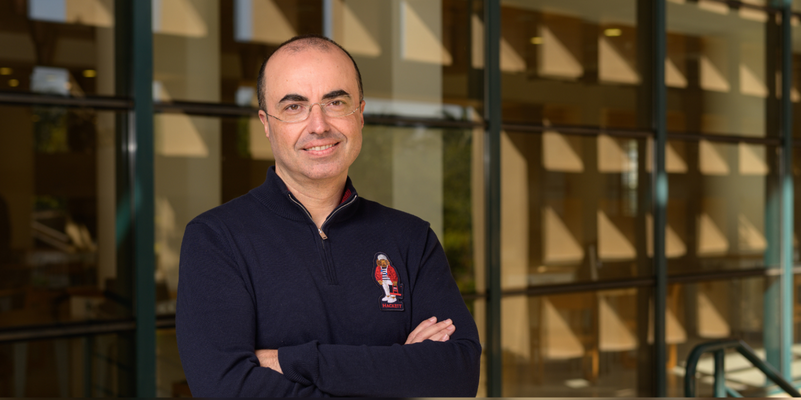 Professor Mohamed Salama standing in front of the AUC library