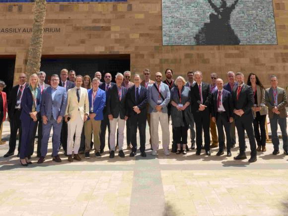 A group photo of visiting AAICU leaders standing in front of Bassily Auditorium at AUC New Cairo Campus