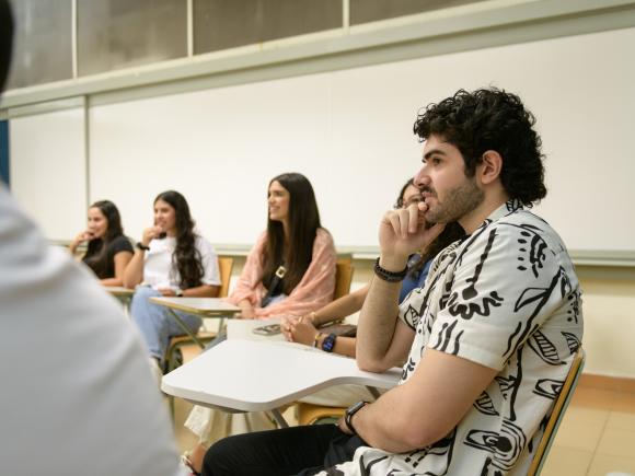 a student sitting in classroom with his classmates