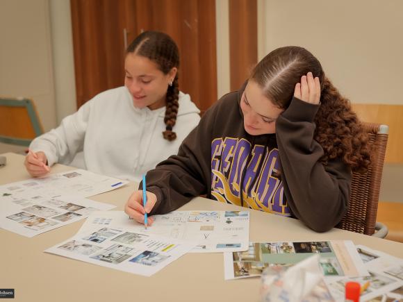 2 girls drawing interior sketches in class