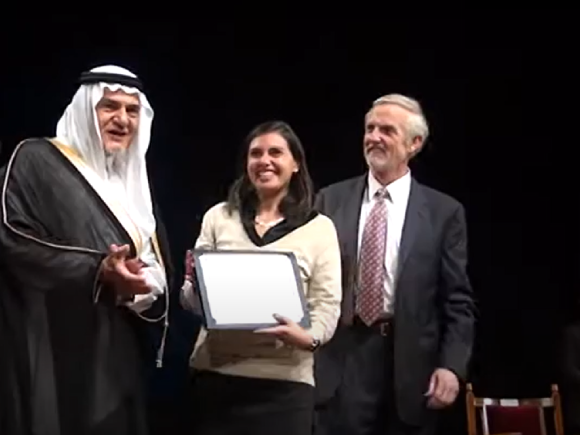 President Ad Interim Thomas E. Thomason and His Royal Highness Prince Turki Al Faisal giving a certificate to a female veiled winner 