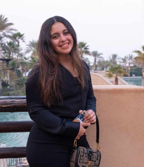 Headshot of Maryam Elshanawany in front of the backdrop of Dubai