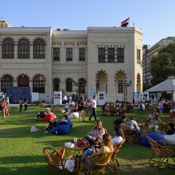 People sitting on tables at AUC Tahrir Square Campus garden