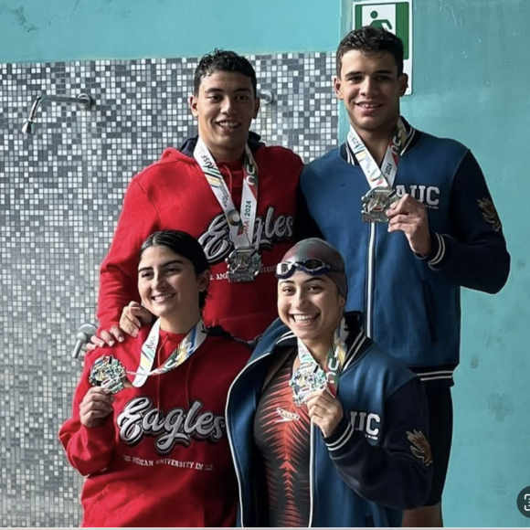 auc students winning at a swimming competition in Rome