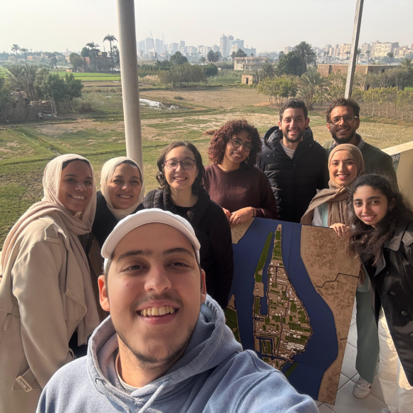 A group of students smiling and taking a selfie on Qursaya Island