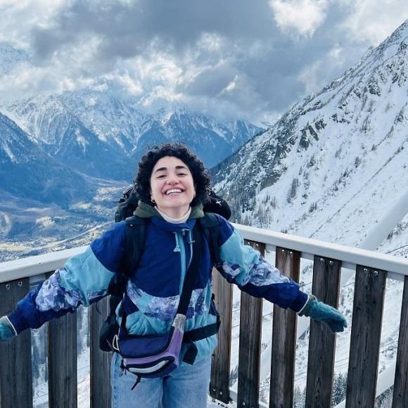 Girl student in the snowy mountains in a study abroad trip