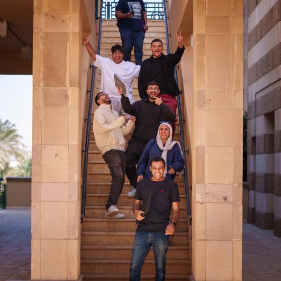 Students are standing on the stairs, they are laughing